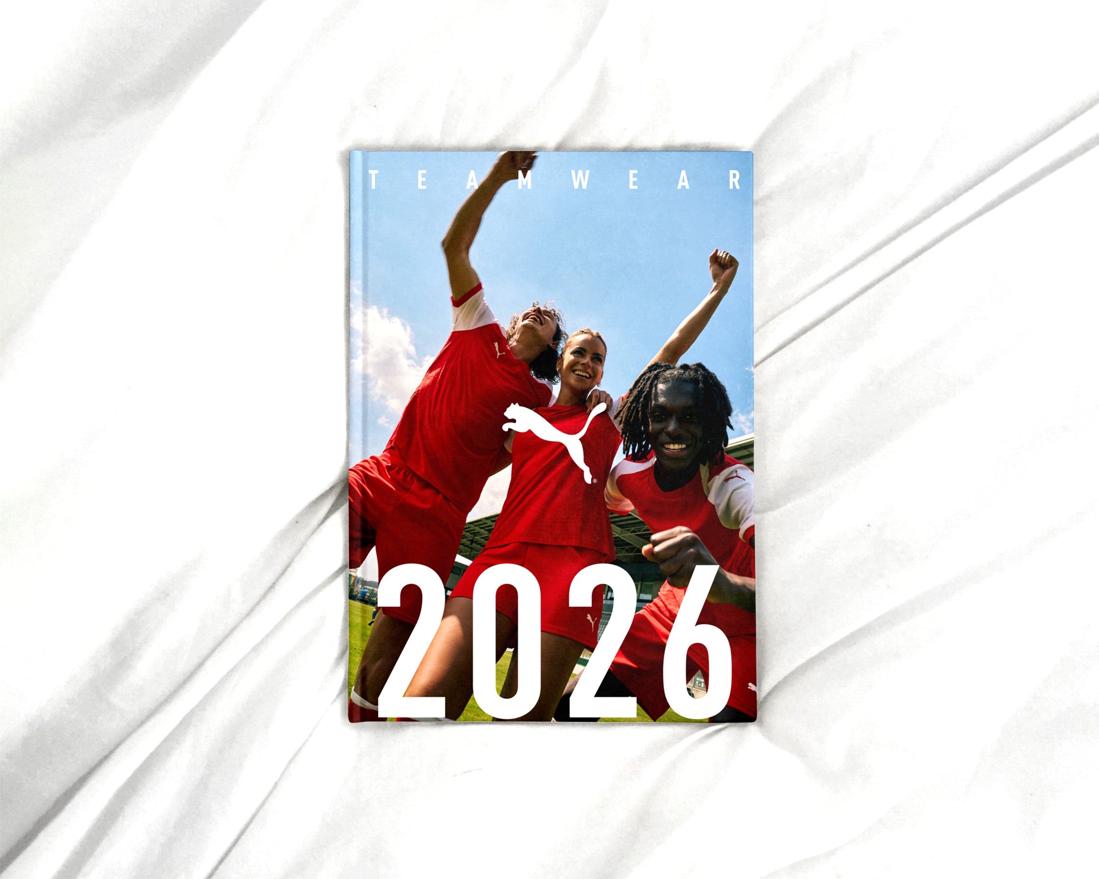 Promotional poster for Puma featuring soccer players and the year 2026 on a white background.